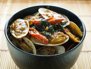 STIR FRIED CLAMS WITH ROASTED CHILI PASTE AND THAI BASIL LEAVES.