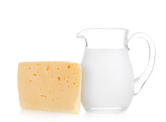 Big piece of cheese, glass jug with milk