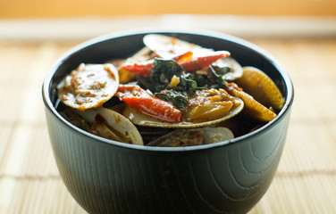 STIR FRIED CLAMS WITH ROASTED CHILI PASTE AND THAI BASIL LEAVES.