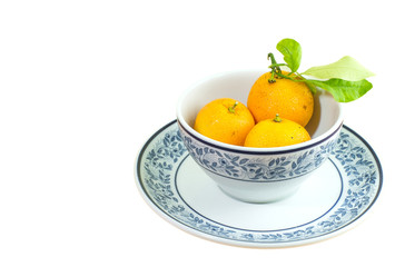orange in the cup isolated on white background