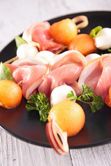 finger food with melon,mozzarella and prosciutto