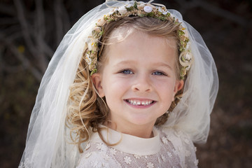 Girl in holy communion dress and veil