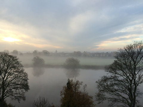 Sunrise through a foggy start of the day over the river Trent