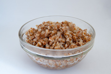 buckwheat in a glass container on white background