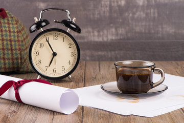 Old clock, hat, coffee and paper sheets