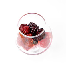 mixed berries fruit in glass on white background.