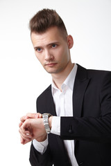 businessman in a suit looking at his watch