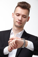 businessman in a suit looking at his watch