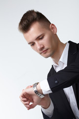 businessman in a suit looking at his watch