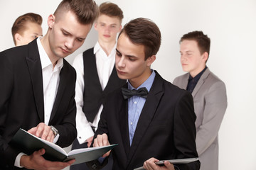 a group of young businessmen looking at paperwork