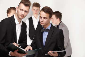 a group of young businessmen looking at paperwork