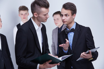 Fototapeta premium a group of young businessmen looking at paperwork