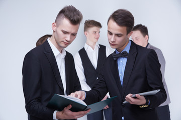 a group of young businessmen looking at paperwork