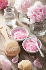 Obraz na płótnie Canvas spa set with peony flowers and pink herbal salt