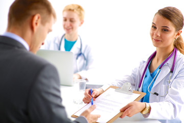 Fototapeta premium Medical team sitting at the table in modern hospital