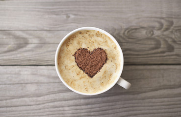 Heart from chocolate on coffee. Concept and idea