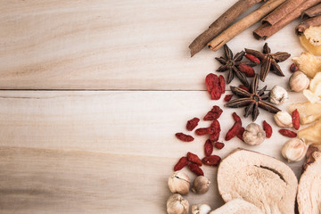 Ingredients for Chinese herbal soup on wooden background