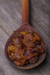 Raisins in a old wooden spoon