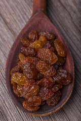 Raisins in a old wooden spoon
