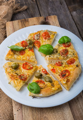 Homemade pizza with cheese and tomatoes on wooden table