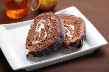 Slices of Yule log cake on a Christmas table