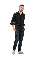 Naklejka premium Young man in black shirt with rolled up sleeves walking isolated