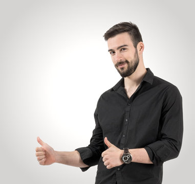 Portrait of young happy smiling man with thumbs up gesture