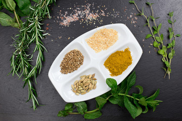 Fototapeta na wymiar aromatic herbs and spices over slate sheet