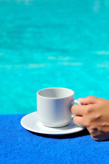 Closeup image of real attractive female beauty holding cup of co