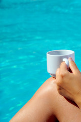 Closeup image of real attractive female beauty holding cup of co