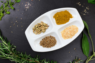 aromatic herbs and spices over slate sheet