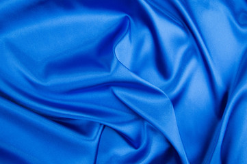 Blue silk background. Close up.