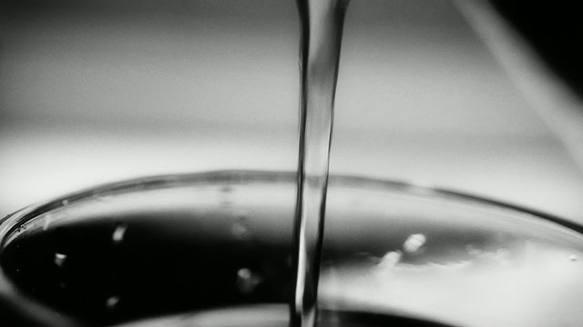 Close up on rinsing water. Panning. BW with a touch of grain.