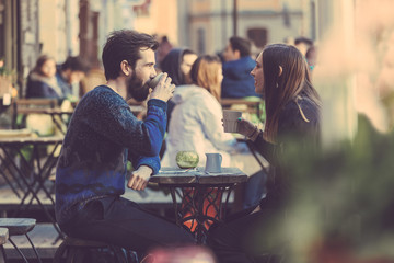Hipster couple drinking coffee in Stockholm old town.