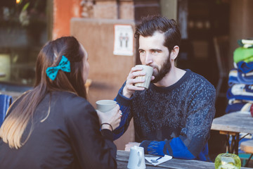 Hipster couple drinking coffee in Stockholm old town.