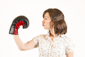 Beautiful woman pretending to kiss boxing glove
