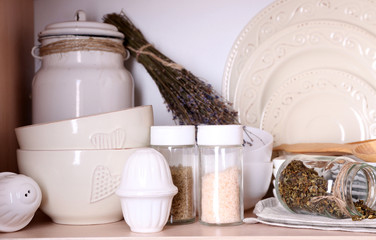 Kitchen utensils and tableware on shelf