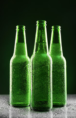 Glass bottles of beer on dark background