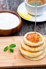 cheese pancake with soured cream and dripping honey