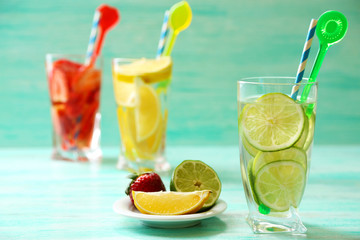 Cocktails with fresh strawberries and lemon lime on wooden background