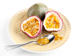 Passion fruit on plate isolated on white