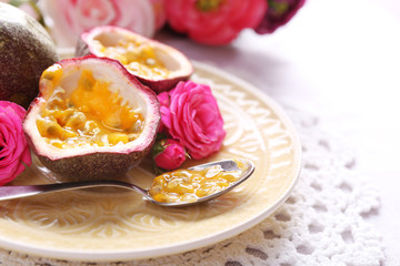 Passion fruit on plate on color wooden background