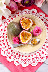 Passion fruit on plate on color napkin background