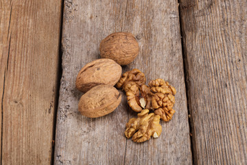 Raw Organic Walnuts on rustic old wooden table