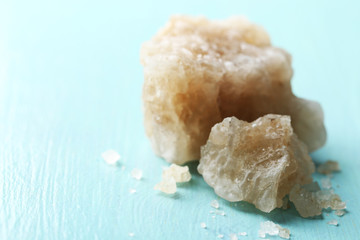 Crust of sea salt from Dead Sea coast, on color wooden background