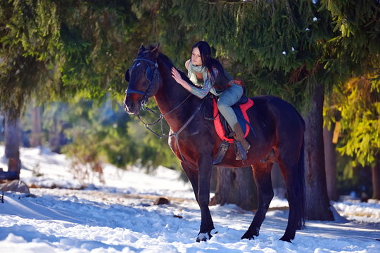 young woman riding horse outdoor