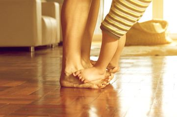 Playful mother and son feet