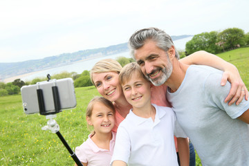 Family in vacation taking selfie picture with smartphone © goodluz