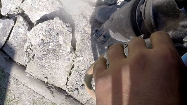 Roadworks, jackhammer breaking pavement, slow motion