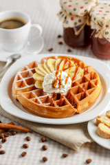 Belgian waffles with bananas and whipped cream